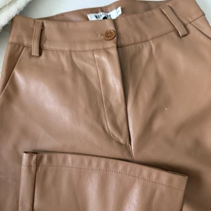 Brun/Beiga skinnbyxor från Madlady - Brun/Beiga utsvängda skinnbyxor från Madlady.