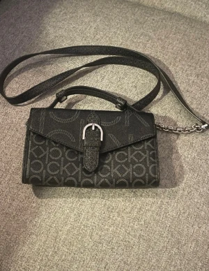 Svart axelväska från Calvin Klein - Lite små slitage i övrigt fin se bilder 