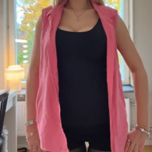 Rosa väst - Snygg rosa väst med krage. Samt knappar,så den går att stänga.Enkel att styla med tex en basic tröja.