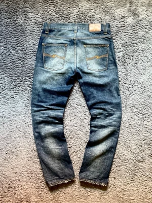 Nudie Jeans  - Säljer ett par riktigt feta Nudie Jeans!!  Stick: 10/10!  Knappt använda!   Storlek: 30W 32L Model: Grim Tim!  Väldigt snygg blandning av marinblå och grå!     Hör av er vid minsta fundering!! 💭 !!!Gå in på mitt konto för flera grymma plagg!!!