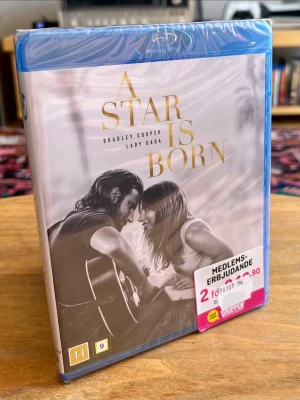 NY / INPLASTAD! A Star Is Born (Blu-ray) – Bradley Cooper & Lady Gaga! - Helt ny, oöppnad och fabriksinplastad köpfilm på Blu-ray med det fyrfaldigt Oscarsnominerade och hyllade musikaliska dramat ”A Star Is Born” från 2018. Kampanjklistermärket sitter kvar orört på plasten – ett perfekt kvitto på att filmen aldrig varit öppnad!