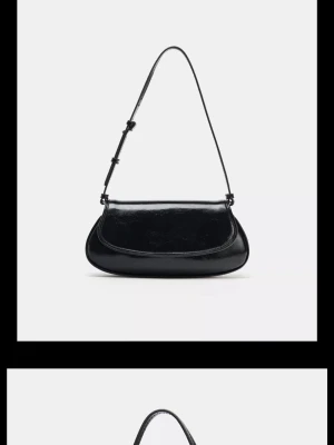 Svart axelväska i glansigt material - Säljer denna svarta handväska från Zara som just nu är helt slutsåld. Använd max tre gånger. 