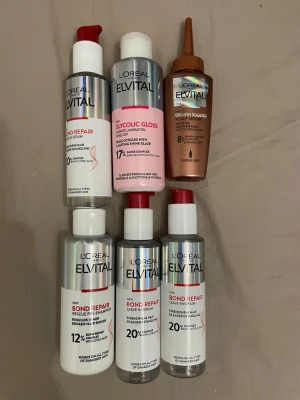 L'Oréal Elvital hårvårdsprodukter - Säljer ett set med sex olika hårvårdsprodukter från L'Oréal Elvital. Innehåller Bond Repair-serum, Glycolic Gloss leave-in och Growth Booster. Produkterna kommer i silvriga, vita och kopparfärgade flaskor med pump och pipett. Perfekt för dig som vill stärka och vårda håret.