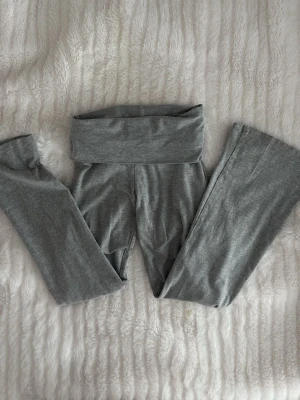Grå leggings från Gina Tricot - Snygga grå leggings från Gina Tricot med bred linning och stretchigt material. Perfekta för en avslappnad look och superbekväma att bära hela dagen. Passar till både oversized tröjor och crop tops.🫰🏻❤️ PRUTA NER PRISET OM NI VILL 
