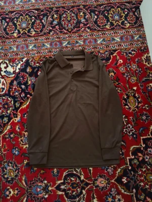 Brun långärmad polotopp i bomull - Storlek M men passar XS!