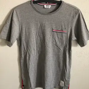 Women’s Thom Browne Classic Pocket T-Shirt  Size small, regular small fit.  Excellent condition, no flaws or damage.  DM if you need exact size measurements.   Buyer pays for all shipping costs. All items sent with tracking number.   No swaps, no trades, no offers. 