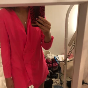 Rosa kavajklänning - Säljer denna riktigt snygga kavaj klänningen från boohoo💗💗 helt oanvänd då jag inte hann skicka tillbaka den(prislapp kvar). Färgen syns bäst på de första två bilderna, köparen står för frakten! Bara att skriva ifall du undrar något