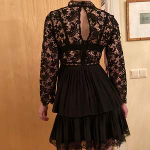 A black open back lace dress with layers. Long sleeves, very elegantti and Classic. Never used. 