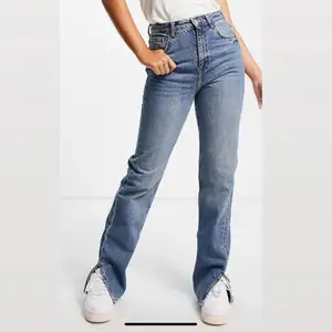 Blå raka jeans i 90-talsstil med slits nertill från Pull& Bear. Storlek 32, den passar längre tjejer . Har missat retur datum så den är helt ny med pris lappar på. 