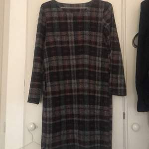 Dress made in Italy with different purple shades tartan pattern. In perfect condition. Material is quite warm so works well for colder weather. Does not have a size tag on but it fits a size M.