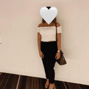 White off shoulder cropped shirt, a bit see through, not too soft. Size S runs for M as well