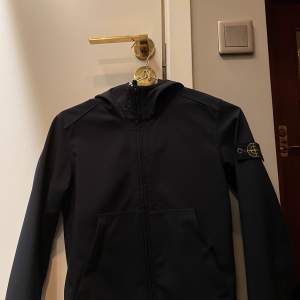 En Stone island Shell jacket junior. Storlek 142/10 år. Den är köpt på kiddies på Östermalm i Stockholm. Använd ett flertal gånger men ändå i jätte bra skick. Säljer den på grund av att den är för liten. Detta är ett äkta plagg. Färg marinblå. Nypris 2500 mitt pris 600kr