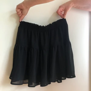 Kjol - Svart kjol i 100% polyester. Kjolen är i storlek 40 men passar en S. Den är från H&M.                                      Köparen står för frakten!