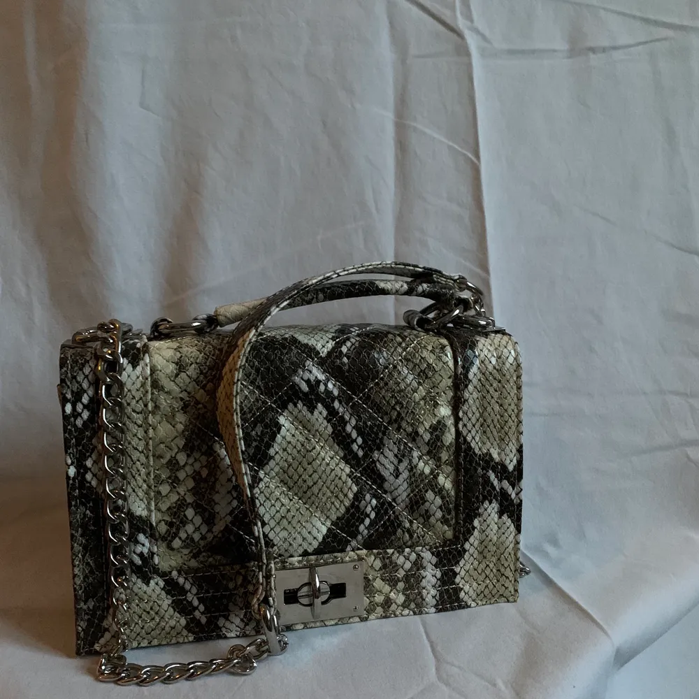 Handväska från Gina Tricot i snakeprint. Oanvänd men tyvärr utan prislapp! . Väskor.