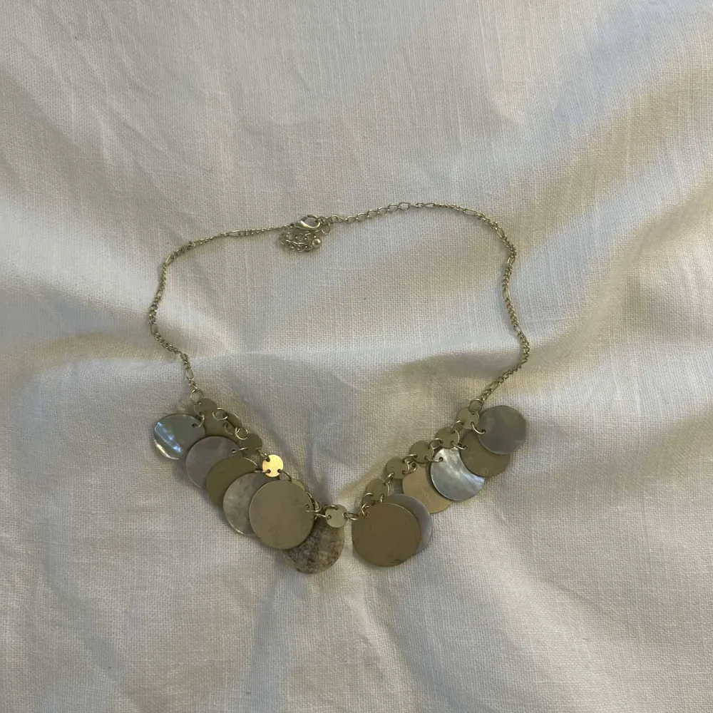 Halsband med guldiga runda berlocker . Accessoarer.