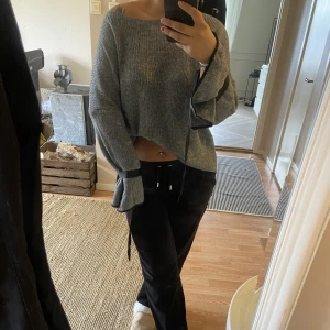 Stickad tröja - en grå stickad tröja med snörningar runt handlederna jättebekväm onesize skulle säga passar S-L!