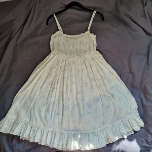 Oanvänd bommulsklänning från ralph lauren - En superfin blåblommig klänning från ralph lauren av 100% bommul. Har tyvärr aldrig använt den men förhoppningsvis så kan någon annan få glädje av den! Passar storlek S till L.