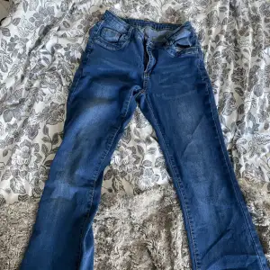Låg midjade jeans en liten lös tråd längst ner på höger ben som går att klippa av 