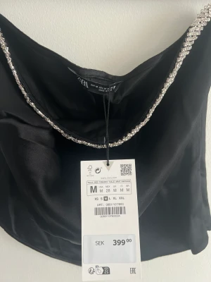 ZARA Black Satin Rhinestone tubtopp - Never used bc it did not fit me, very pretty black satin tube top with a rhinestone detail obove the chest area