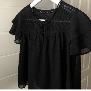 Svart blus - Jättefin blus, den är genomskinlig i ryggen. Lånade bilder. Köparen står för frakten, hör gärna av er vid frågor.