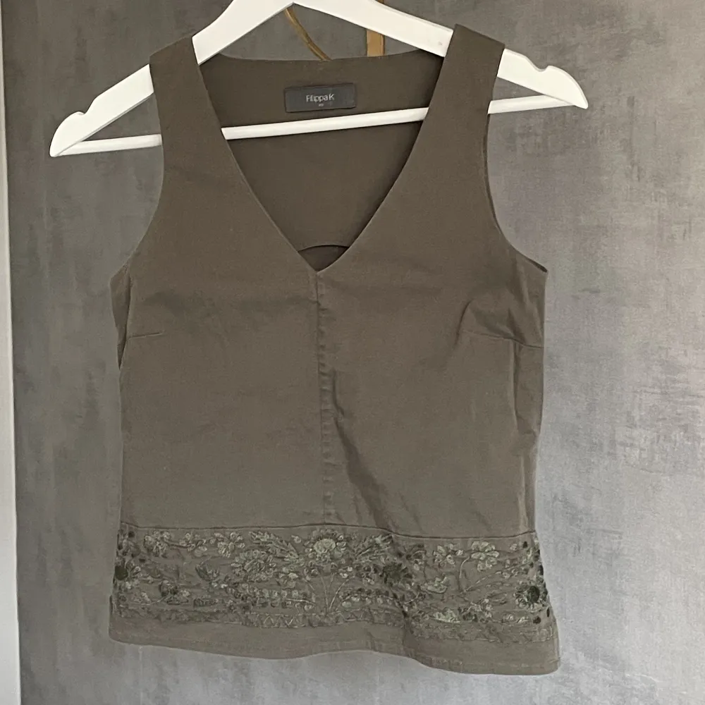 Söt topp från Filippa k med broderade blommor längst ner💚 färgen är militärgrön/ khaki. Den är true to size! Materialet är ej stretchigt💚. Yläosat.