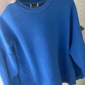 En oversized blå tröja som är använd flera gången men är i bra skick utan hål eller fläckar 