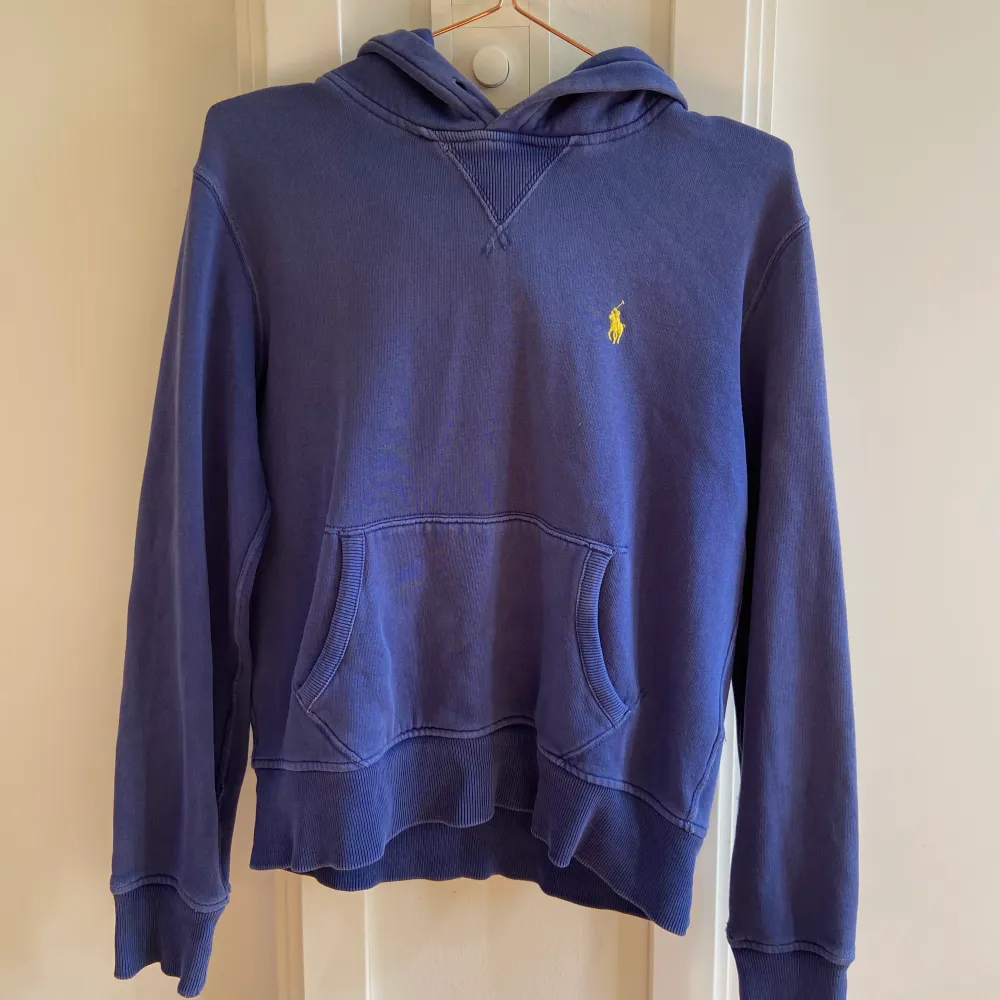 En blå hoodie från Ralph Lauren som har visa defekter på ärmarna men annars i hyfsat fint skick. Hoodies.
