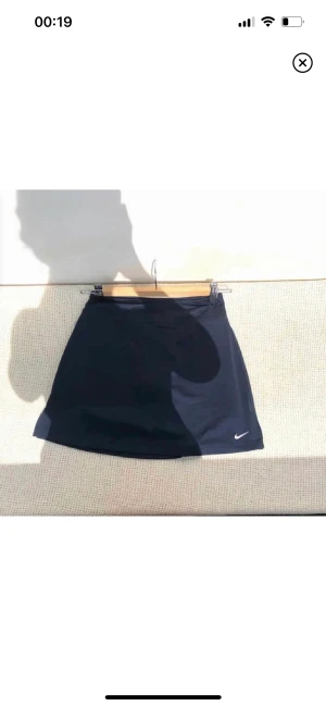 Nike tennis kjol - Säljer denna marinblåa tenniskjolen från Nike. Storlek Dam XS. Prislappar och allt på<3  Bilderna är lånade från förra säljaren som jag köpte ifrån, säljer då den tyvärr var lite för liten för mig<3