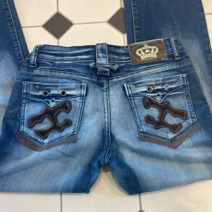 Jeans - Midjemått tvärs över 36cm innerbenslängd 73cm. Obs saknar knapp se sista bild. Byxorna är uppsydda går o sprätta upp för att få längre