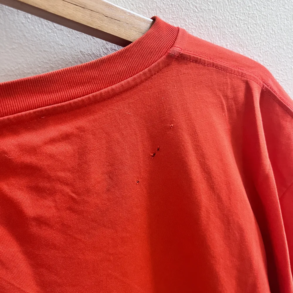 Size m   små hål. (Se bild)  Orange. T-shirts.