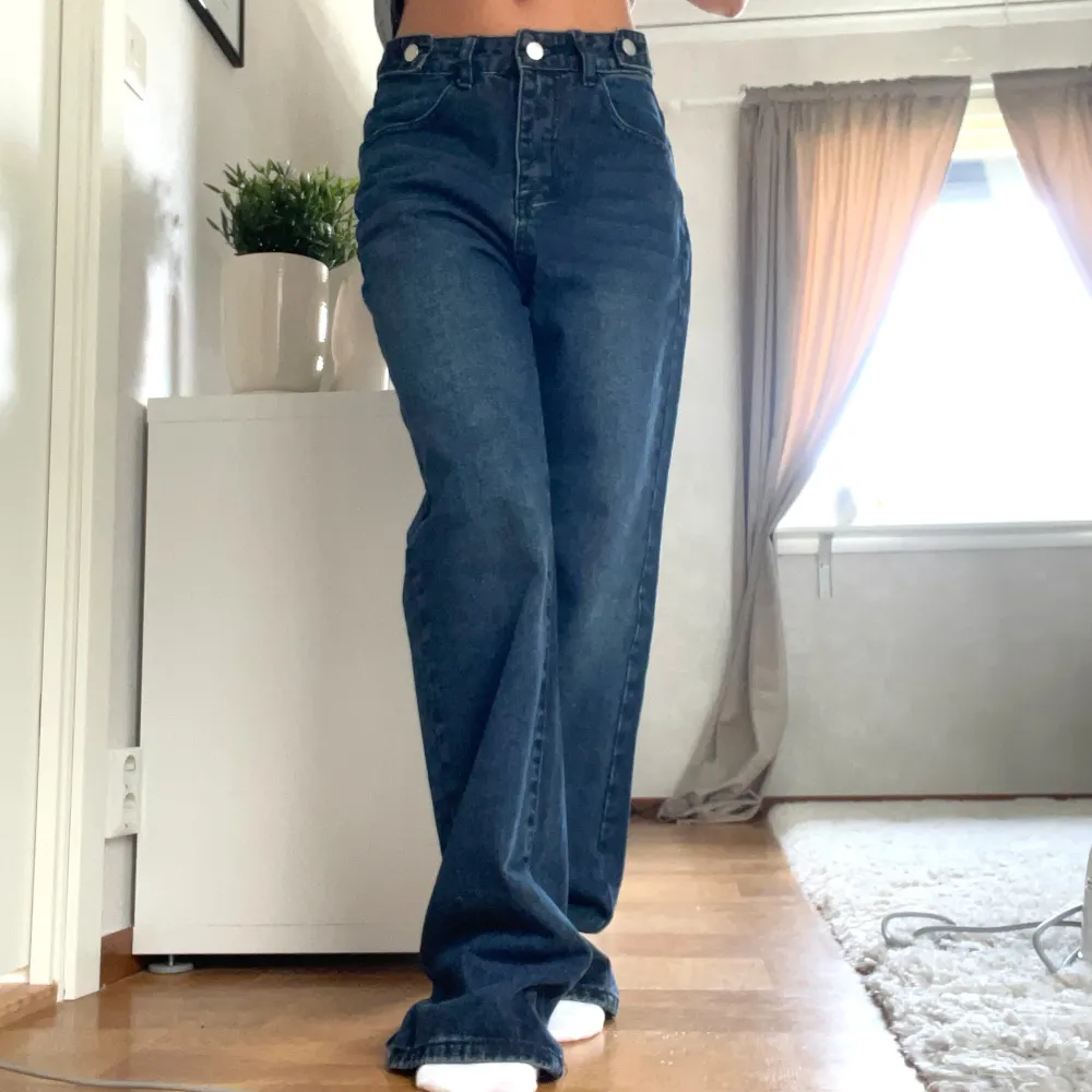 Säljer ett par snygga mörkblå jeans med hög midja. De har en straight passform som ger en avslappnad look. Perfekta för både vardag och fest! 🖤. Jeans & Byxor.