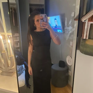 Open back klänning - Elegant svart långklänning med ärmlös design och öppen rygg. Perfekt för en stilren och sofistikerad look.