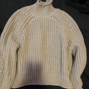 Grå stickad polotröja (SWISH ENDAST!) - Mysig grå stickad polotröja med ribbade detaljer. Perfekt för kyliga dagar med sin höga krage och långa ärmar. En klassisk och stilren design som passar till det mesta.