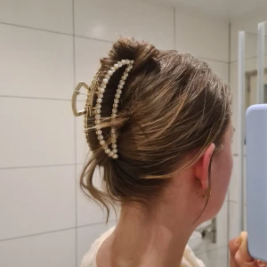 Hårklämma med pärlor och strass - Hårklämma i guldfärg med pärlor och strassdetaljer. Klämman är väldigt stabil och stark så den kan hålla rätt mycket hår.