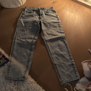 Blå  jeans - Säljer ett par blåa  jeans med en avslappnad passform. Byxorna har en klassisk design. Perfekta för en casual look. 