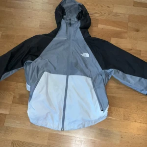 Grå och svart vindjacka från The North Face - Säljer en grå och svart vindjacka från The North face storlek m