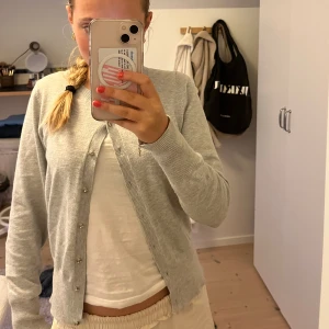 Stickad kofta - Säljer en ljusgrå stickad kofta från Holly & Whyte by Lindex. Stl S. 