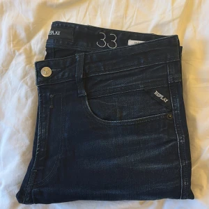 Mörkblå jeans från Replay - Hej, säljer dessa replay jeans som är i modell anbass. Jeansen är i ett mycket fint skick. Jeansen är i W33 men kan lösa mått om man är osäker på längden. Jeansen har inga deffekter eller täcken på användning och kostar i ny pris ca 1800kr.