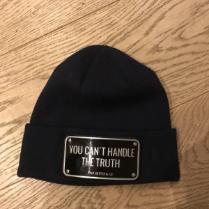 John hatter & co mössa ”You can’t handle the truth “ - Säljer en blå mössa från John hatter med texten 'YOU CAN'T HANDLE THE TRUTH'. Mössan är i bra skick och passar perfekt för höst och vinter. Nypris ca 1000. 