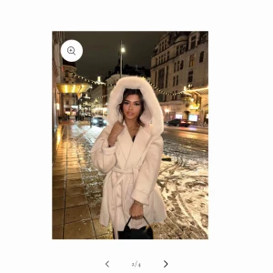 Vit kappa med pälskrage - Säljer en superfin vit kappa från fur Stockholm med fluffig pälskrage och knytskärp i midjan. Perfekt för vintern och hösten när du vill hålla dig varm och snygg. Den har en elegant och stilren design med stora fickor framtill. Passar både till vardags och festliga tillfällen. 🧥❄️.                                    Jackan är i storlek L men fungerar också som XL.                                                                        Ord pris 2197kr Mitt pris 1500kr