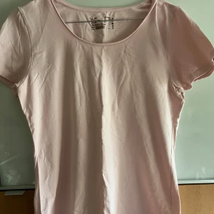 Ljusrosa T-shirt  - Knappt använd t-shirt med stretchigt material. Figursydd. Crew neck. 