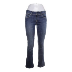 Blå bootcut jeans - Säljer ett par snygga blå bootcut jeans i bra skick. De har en klassisk femficksdesign och är perfekta för både vardag och fest. Jeansen är midwaist och har en bekväm passform som framhäver figuren. Perfekta för höst och vår!
