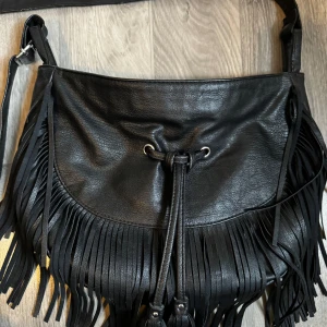 Svart väska  - En svart väska i väldigt bra storlek. Inte för stor men bra utrymme. Säljer då den inte används.