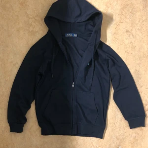 Svart polo hoodie - De är en svart polo hoodie size M, har användt en runt 2-5 gånger, kan skicka ut den från min adressss eller så kan du komma och hämta up den, man kan också diskutera om prisvärdet.