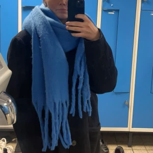 VINTERS FINASTE HALSDUK!!! - Säljer en stor och mysig blå halsduk med långa fransar. Perfekt för att hålla sig varm under kyliga dagar. Den har en enkel design som passar till många olika stilar.💙💙💙💙