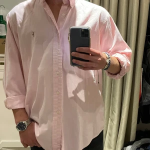 Ljusrosa skjorta med broderad logga - Ralph laruen skjorta rosa | Skick - 9/10 | Size - L | Modell - Classic fit | Pris - 499kr | Modellen är ca 182cm lång | Skriv vid frågor eller funderingar!
