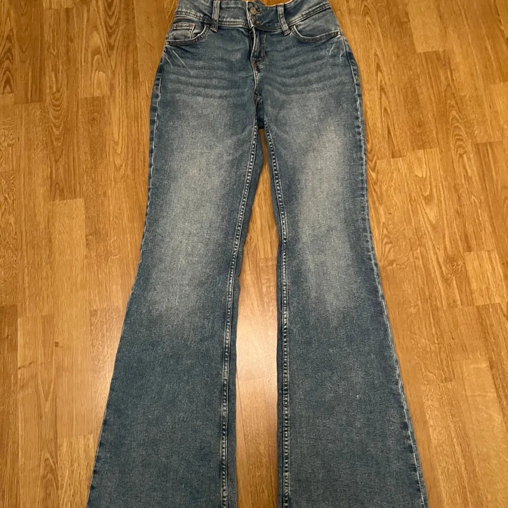 Skit snygga lågmidjade jeans från HM i storlek 38, som har två knappar där fram och knappar och mönster på fickorna där bak. Har inbyggt resor i midjan, går enkelt att ta bort om man ej behöver det och inget som stör.. Jeans & Byxor.