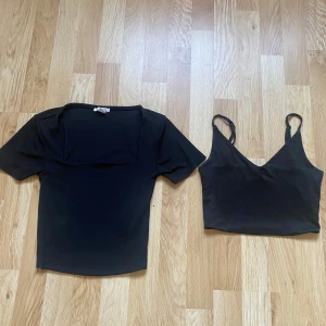 Två svarta plagg. En T-shirt och ett svart linne - Två svarta plagg