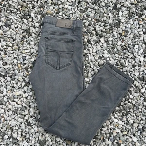 Grå jeansbyxor - Säljer ett par grå slimfit jeans. De har en klassisk femficksdesign och är perfekta för vardagsbruk. Byxorna är i bra skick och passar till de flesta outfits.