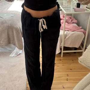 Roxy svarta linnebyxor  - Säljer ett par svarta linnebyxor med vit snörning i midjan. Byxorna har avslappnad passform och raka ben, perfekta för en chill och stilren look. Materialet är lätt och luftigt, vilket gör dem sköna att bära hela dagen.